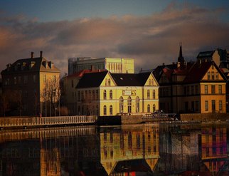 A panoramic view of a large body of water in Reykjavik, reflecting the city's skyline and surrounding landscapes